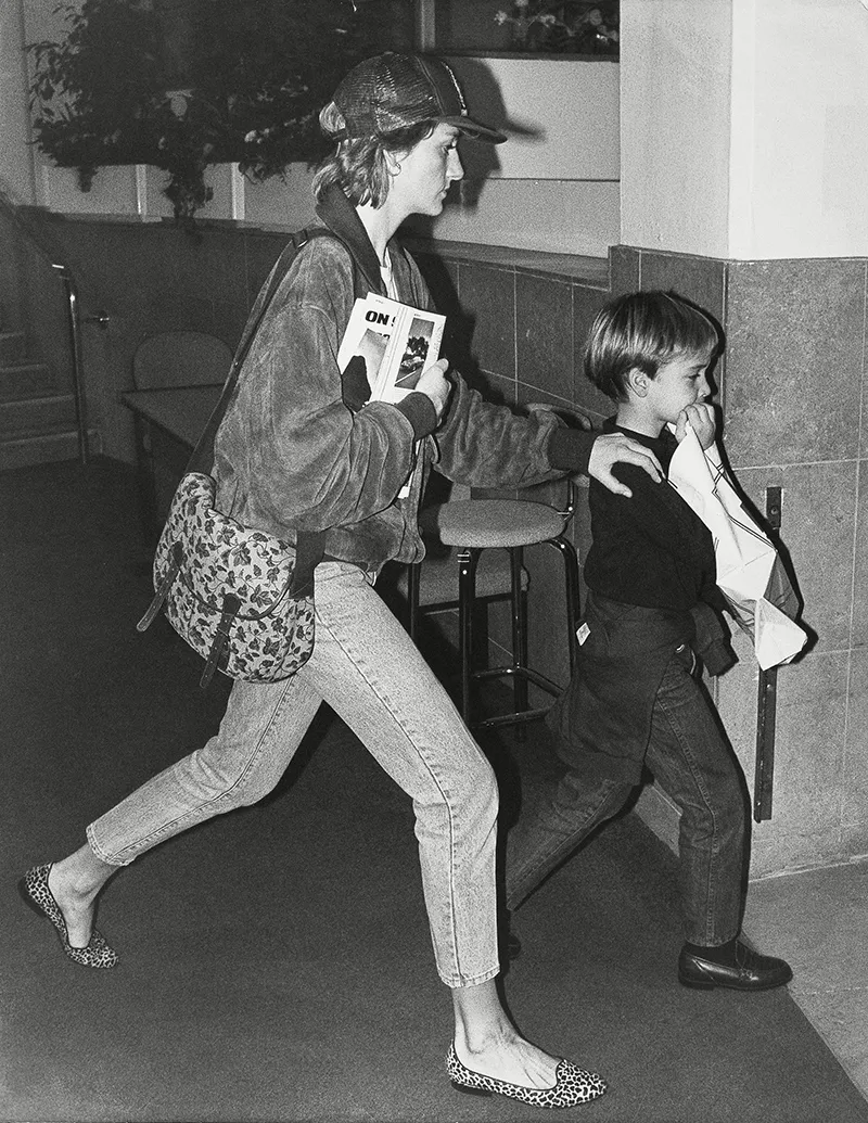 Diana Princess Of Wales - 23rd October 1989. (princess Diana Died 31/8/1997). Prince William Had To Be Restrained By A Motherly Hand As He And The Princess Of Wales Hurried Into Motorfair Today On An Unannounced Private Visit. Like Any Other Young Dr