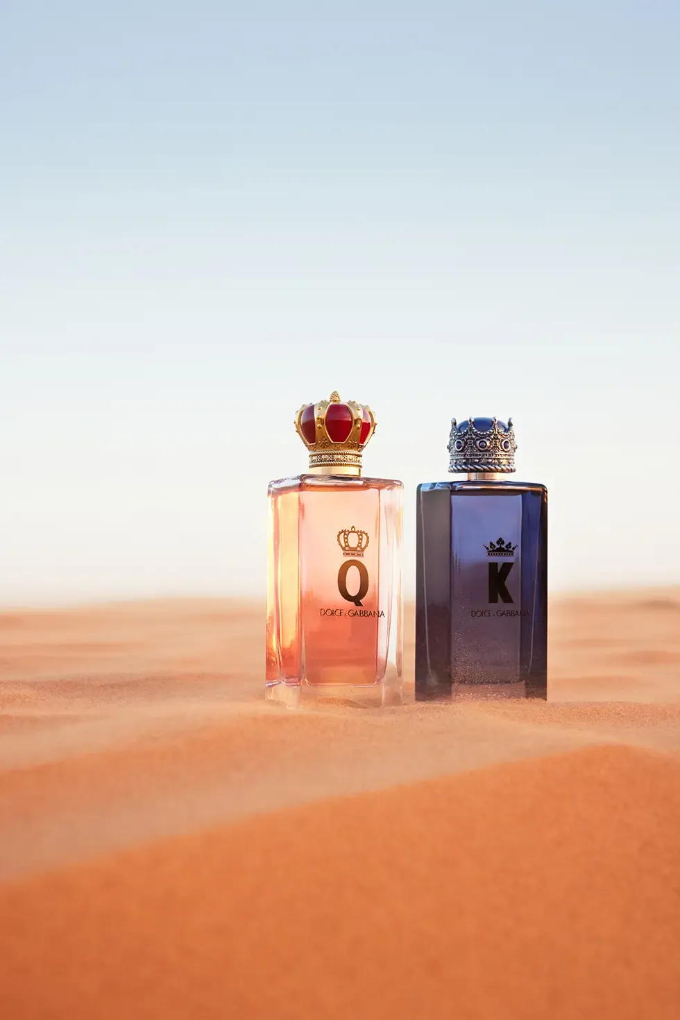 bottles of dandg kandq fragrances on sand