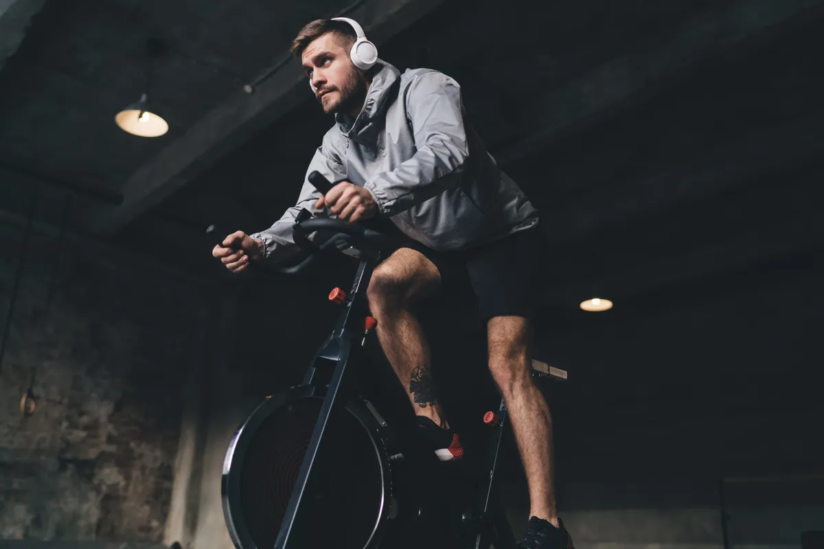 Low,Angle,Of,Young,Male,In,Headphones,Looking,Away,While