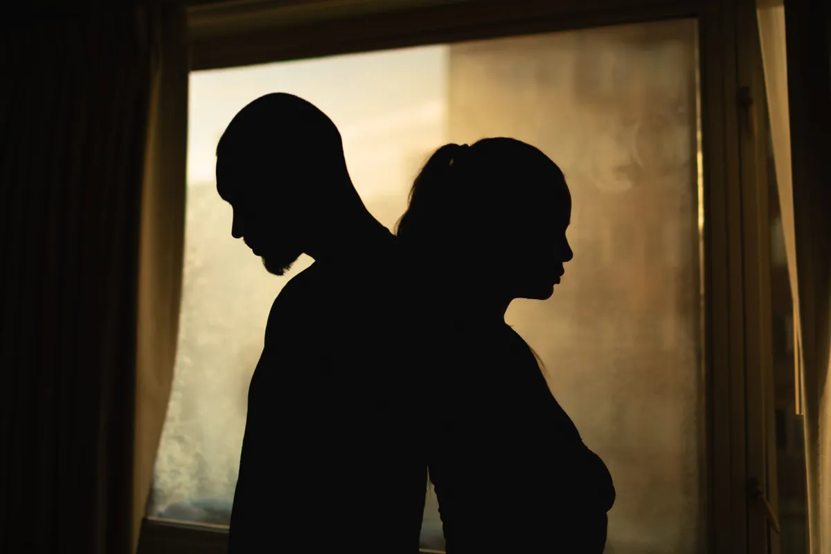 Silhouette of upset  young couple having disagreement, relationship problem, misunderstanding.