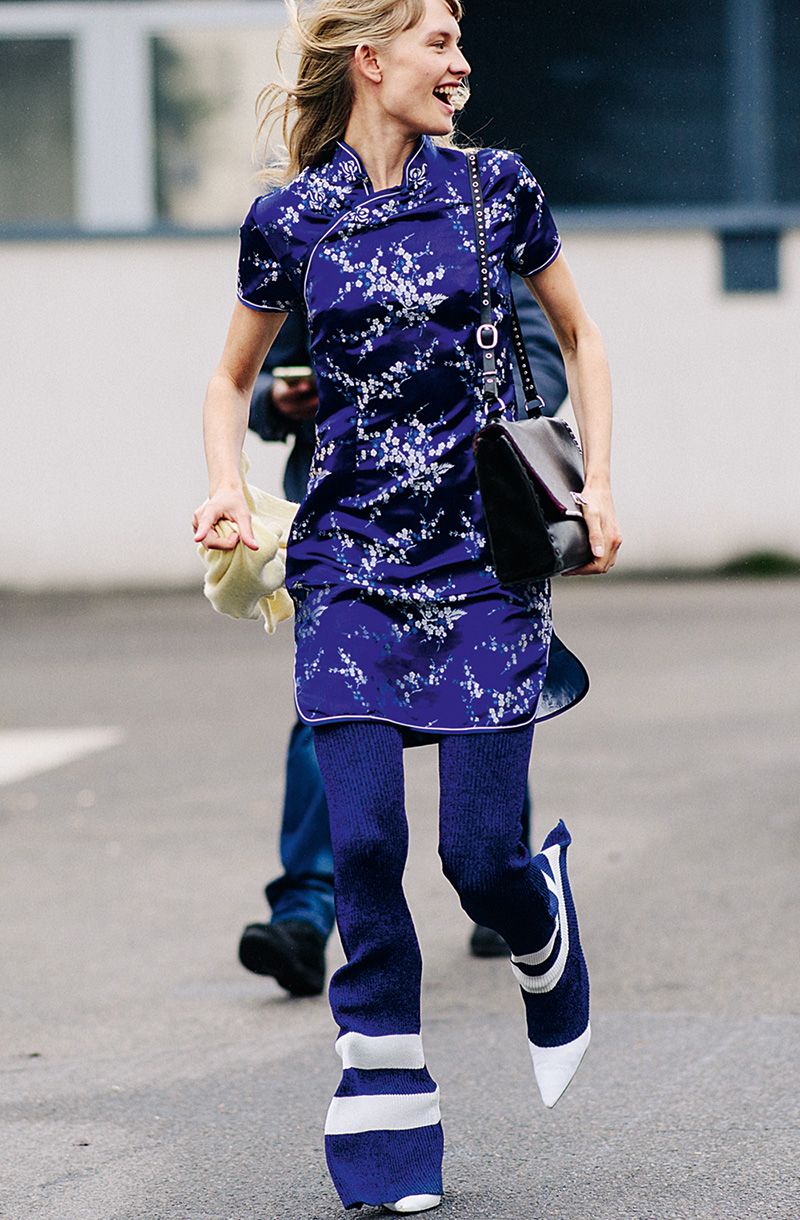 Model wearing blue outfit after a show