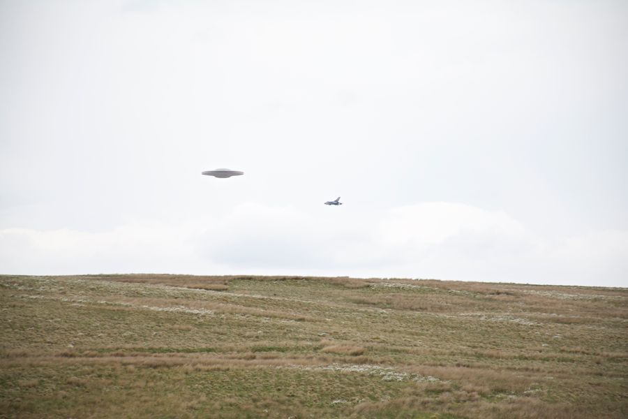 Flying,Saucer,Ufo,Over,Grassy,Moor,Escorted,By,Tornado,Jet